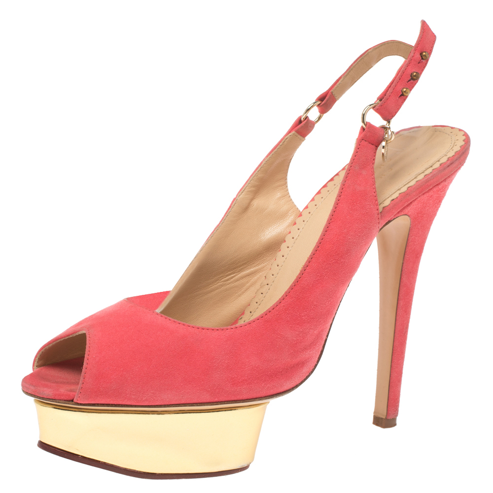 Own this meticulously designed pair of Charlotte Olympia pumps today and dazzle everyone whenever you step out Crafted out of pink suede and lined with leather on the insoles this creation features a peep toe silhouette. They have been beautified with buttoned slingbacks 14.5 cm heels and solid platforms.