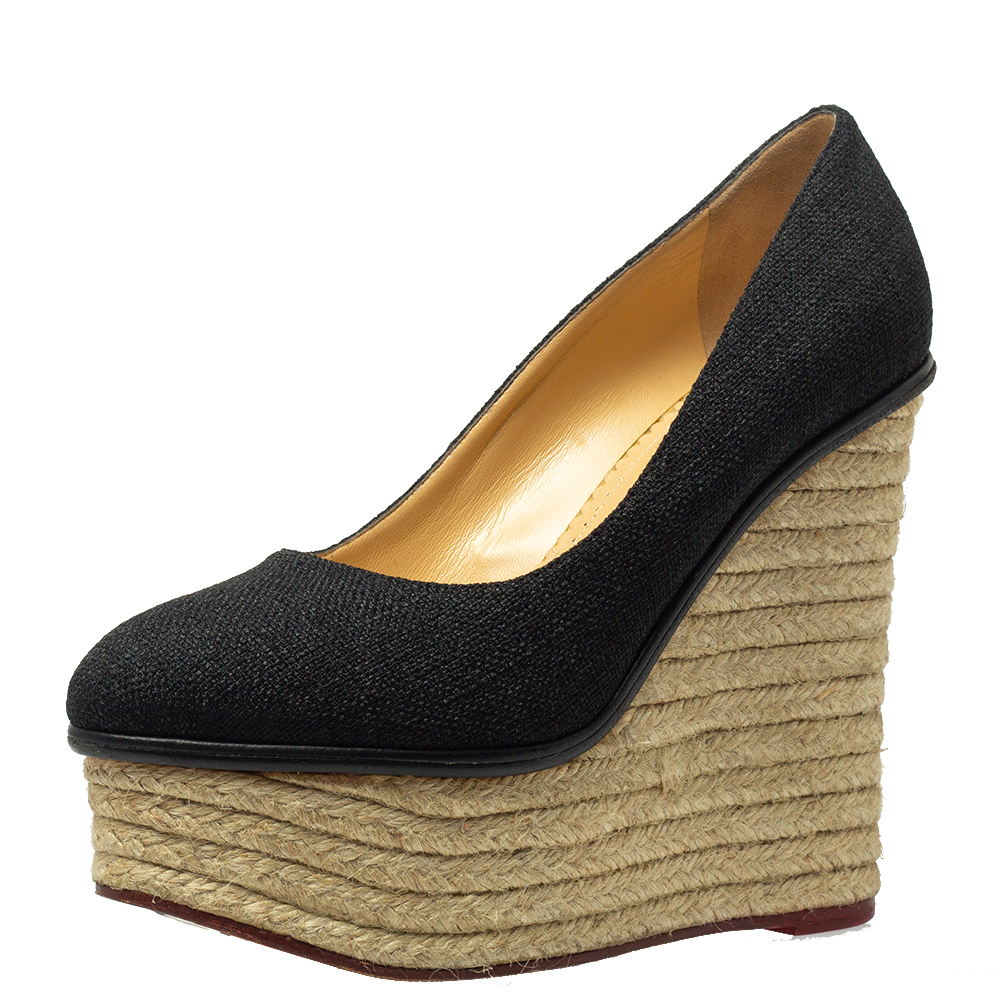 Well isnt this Charlotte Olympia pair simply stunning The pumps have been designed so beautifully with raffia in a black hue that they make ones heart flutter. They come in a simple design of espadrille platform wedges which gives the pair full marks on high fashion.