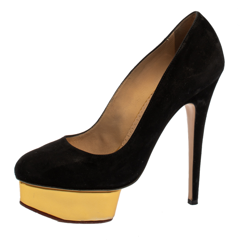 Own this meticulously designed pair of Charlotte Olympia pumps today and dazzle everyone whenever you step out Crafted out of suede and lined with leather on the insoles this creation is from their Dolly collection. They have been beautified with 14.5 cm heels and gold tone platforms for an opulent finish.