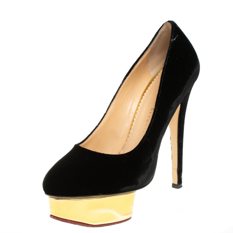Own this meticulously designed pair of Charlotte Olympia pumps today and dazzle everyone whenever you step out Crafted out of velvet and exhibiting almond toes these pumps are from their Dolly collection. They are lined with leather on the insoles and have been beautified with 14.5 cm heels and solid gold tone platforms.