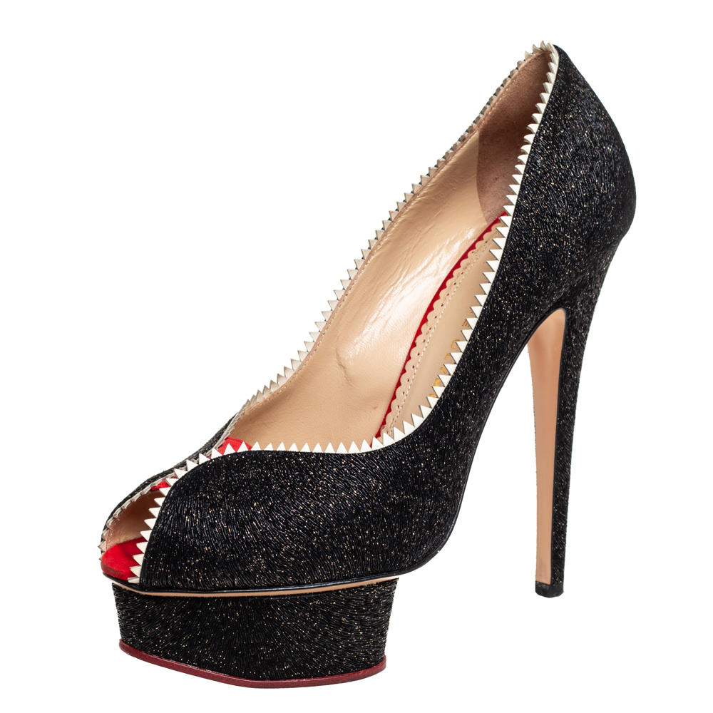 These pumps from Charlotte Olympia are love at first sight The black beauties are exquisitely crafted from glitter and patent leather and designed to please the eyes of the beholder. They flaunt contrast trims peep toes well cut platforms and 14 cm heels to lift you with beauty.