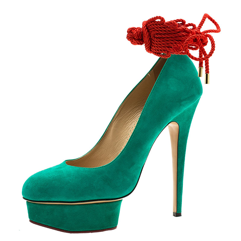 These Charlotte Olympia Dolly pumps will brighten up any look. This fun pointed toe shoes are made from green suede and are complemented with red ankle rope strings. The covered platforms come with 15.5 cm pointed heels. The insoles are leather lined with brand imprints.