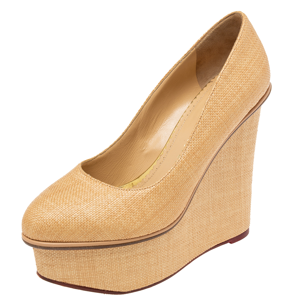 Presented by Charlotte Olympia these Carmen pumps are designed with selective features to offer elegance and poise. They are made from cream yellow raffia on the exterior. They have platforms wedge heels and a slip on closure. Exude charm by wearing these pumps