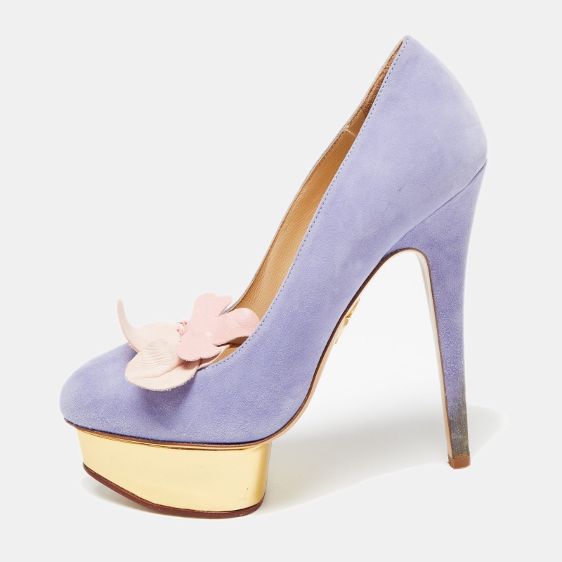Make a statement with this pair of Charlotte Olympia Dolly pumps. Crafted out of suede and lined with leather on the insoles this creation is beautified with high heels platforms and a floral accent on the uppers.