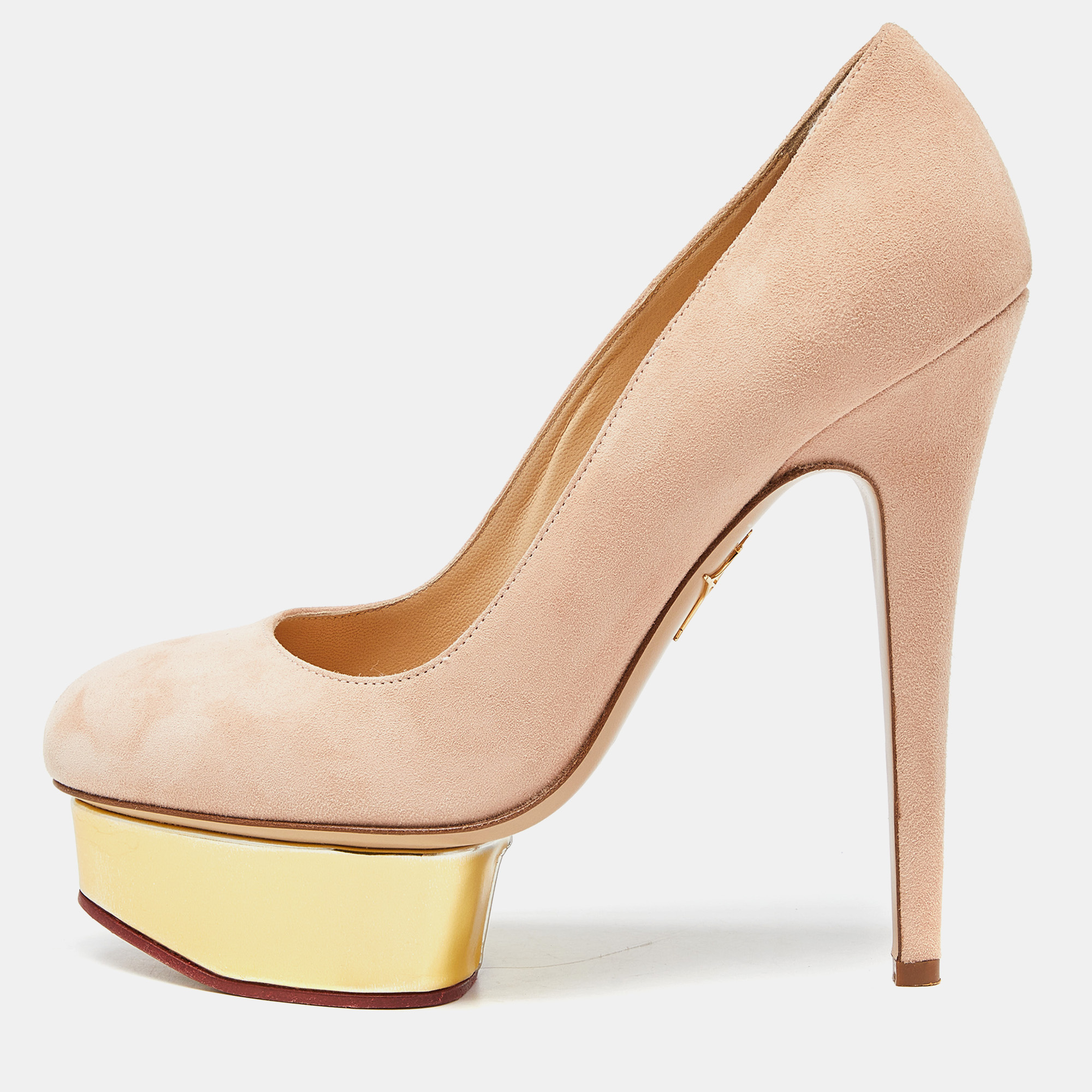 This pair from Charlotte Olympia features the signature dolly platform design. Sleek beige uppers are complemented by gold tone platform islands. A high arch adds to its design and it is finished with a straight stiletto heel.