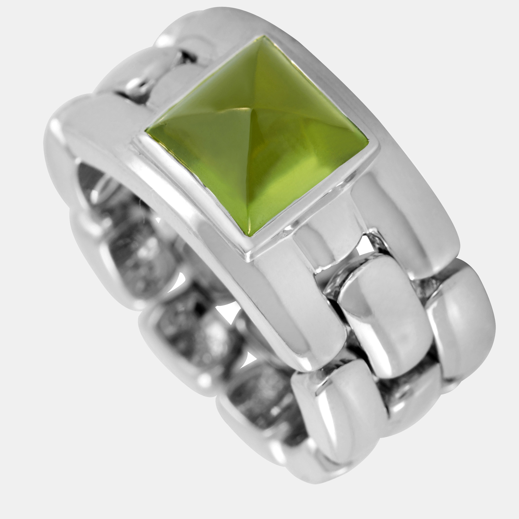 This Chaumet ring is made of 18K white gold and embellished with a peridot. The ring weighs 21.1 grams and boasts band thickness of 11 mm and top height of 6 mm while top dimensions measure 8 by 8 mm.