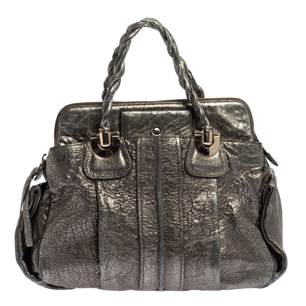 Coveted by fashionable women around the world the Heloise is a bag worth the price. It is from the luxury brand Chloe. The bag is crafted from metallic textured leather and designed with braided handles silver tone hardware and a spacious canvas interior.