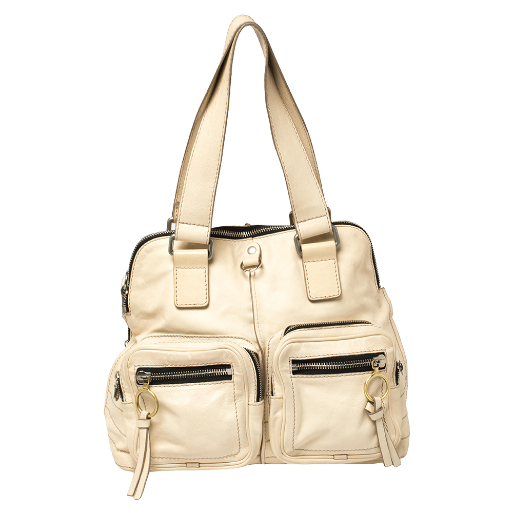 Shaped in a stylish ergonomic design this Chloe Betty bag has everything you would want in a bag. It comes with exterior zipper pockets a spacious fabric lined interior and detailed with silver tone hardware. It comes with two shoulder straps and perfectly sits under your arms.