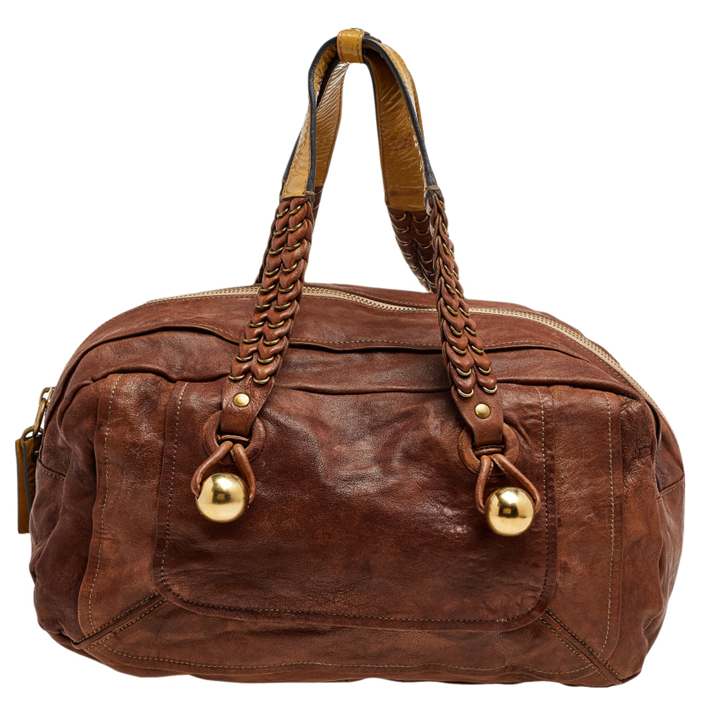 Carry your belongings in style and convenience with this shoulder bag from Chloe. The top zip reveals a canvas lined interior that is capable of storing your items in a safe and secured way. Brown leather is used to craft the exterior of this chic bag.