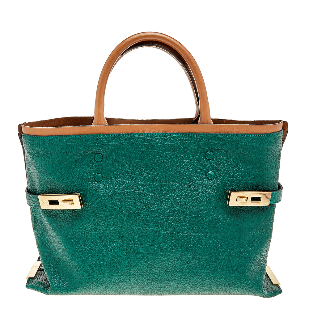 This Chloé Charlotte tote has been crafted from green and brown leather and features dual rolled handles. The tote is styled with gold metal side plates with twist locks on each side. It has a wide top opening to a leather interior that houses two zip pockets to store your daily necessities.