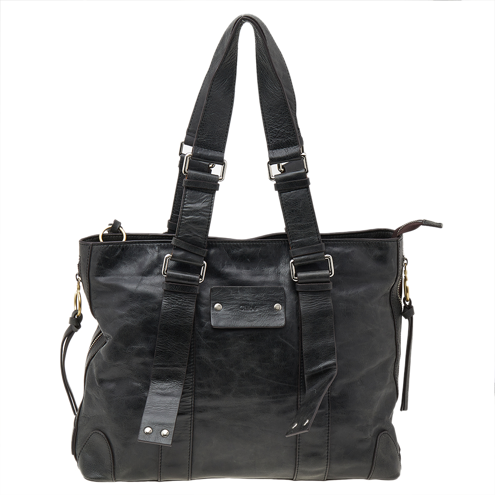 Crafted from leather this black Chloe tote has a zip fastening at the top and a spacious fabric interior. The bag is equipped with two handles and brand detail on the bottom. Swing this beauty on your busy days as it is well made and handy.