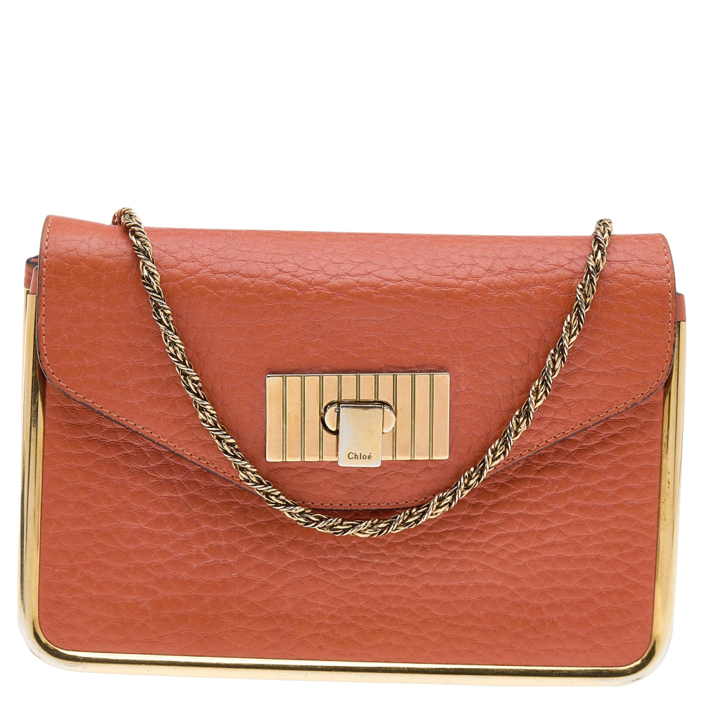 This stylish Sally shoulder bag from Chloe is crafted from orange leather and gold tone metal. The bag features a chain handle and a flip lock on the flap. This Sally is added with a spacious lined interior.