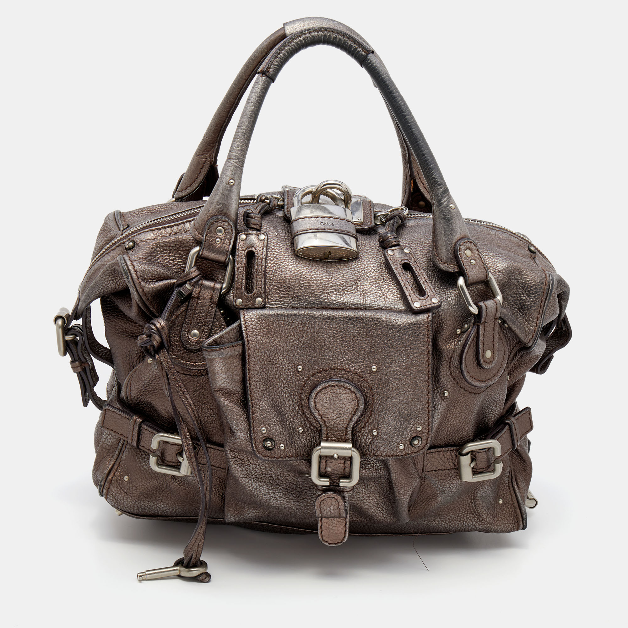 Easy to carry and stylish in appearance this Paddington satchel from the House of Chloe will certainly be your favorite pick this season. It is crafted using metallic brown leather with silver tone hardware elevating its beauty. It provides two handles and a spacious fabric lined interior.