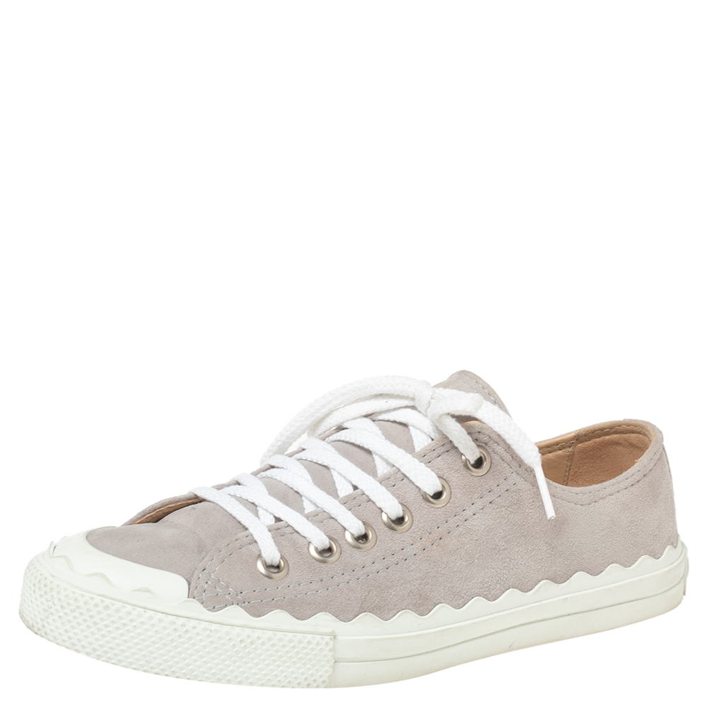 These sneakers are from Chloés Lauren range of designs. Crafted using suede the sneakers are secured with laces and set atop rubber soles. The scalloped detailing around the shoes is a signature of the line.