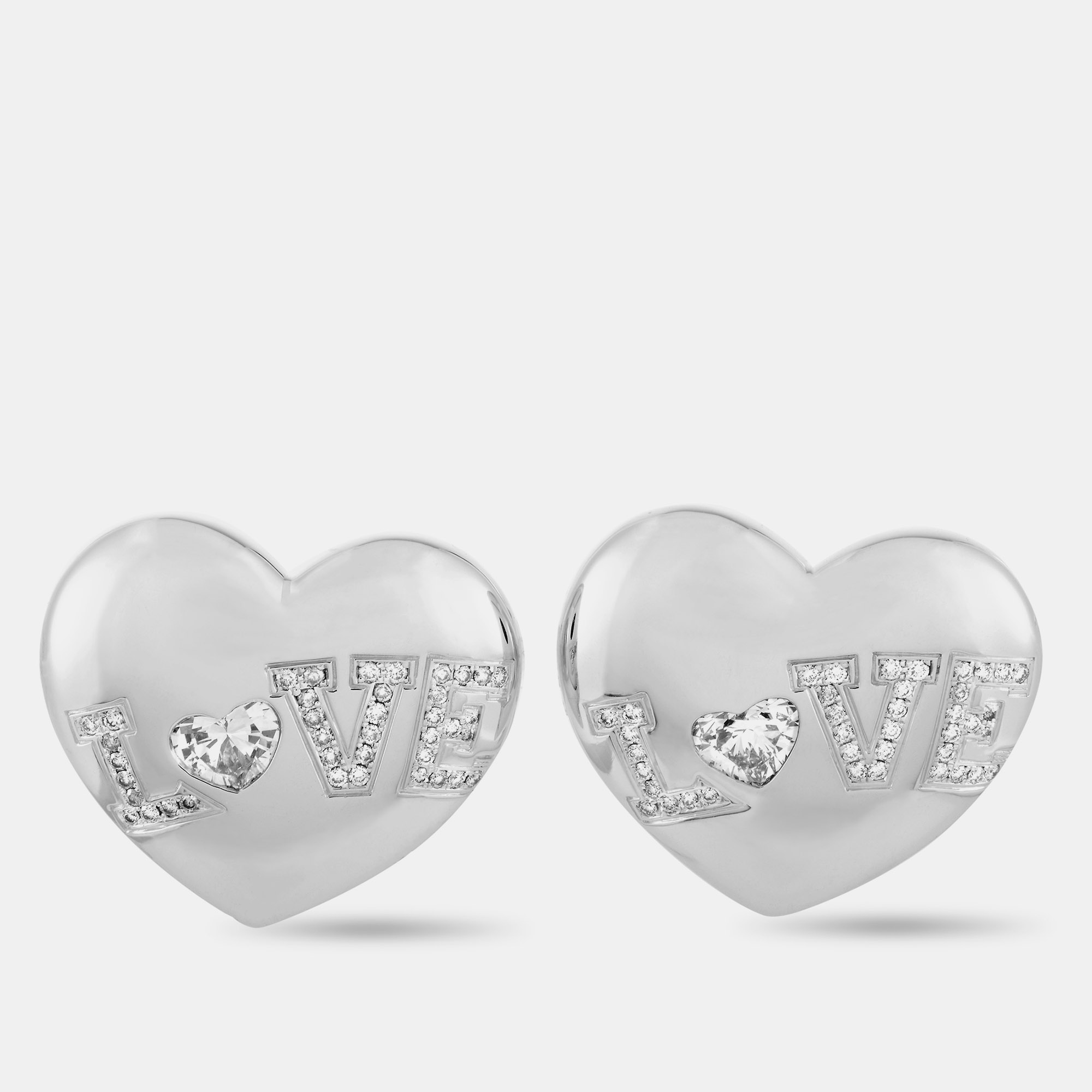 These Chopard earrings are crafted from 18K white gold and set with a total of 1.44 carats of diamonds that feature F G color and IF VVS clarity (the two heartshape stones total 1.03 carats and the remaining stones amount to 0.41 carats). The earrings measure 0.88 in length and 1 in width and each of the two weighs 13.45 grams.