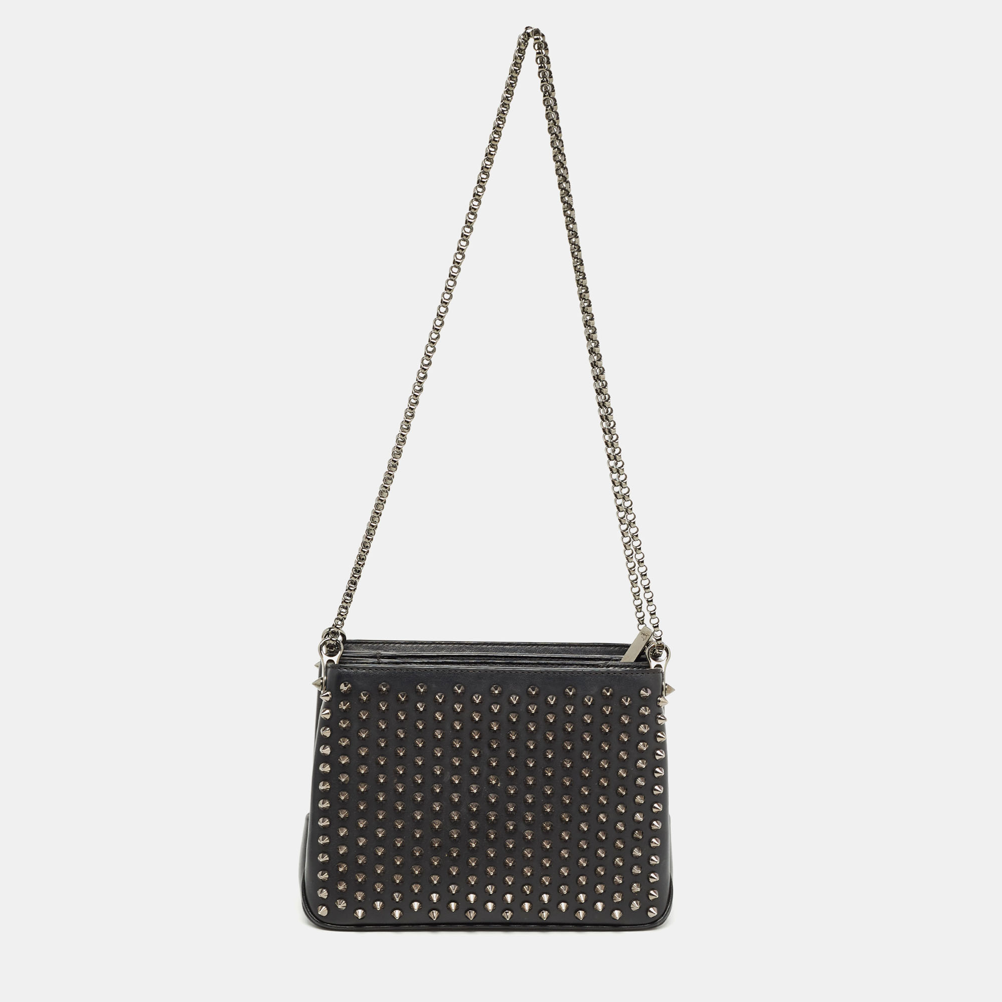 This stylish and elegant bag from Christian Louboutin will be your new favorite accessory Crafted from black leather the Triloubi bag comes with metal spikes on the front and shoulder chains for an easy carrying experience.
