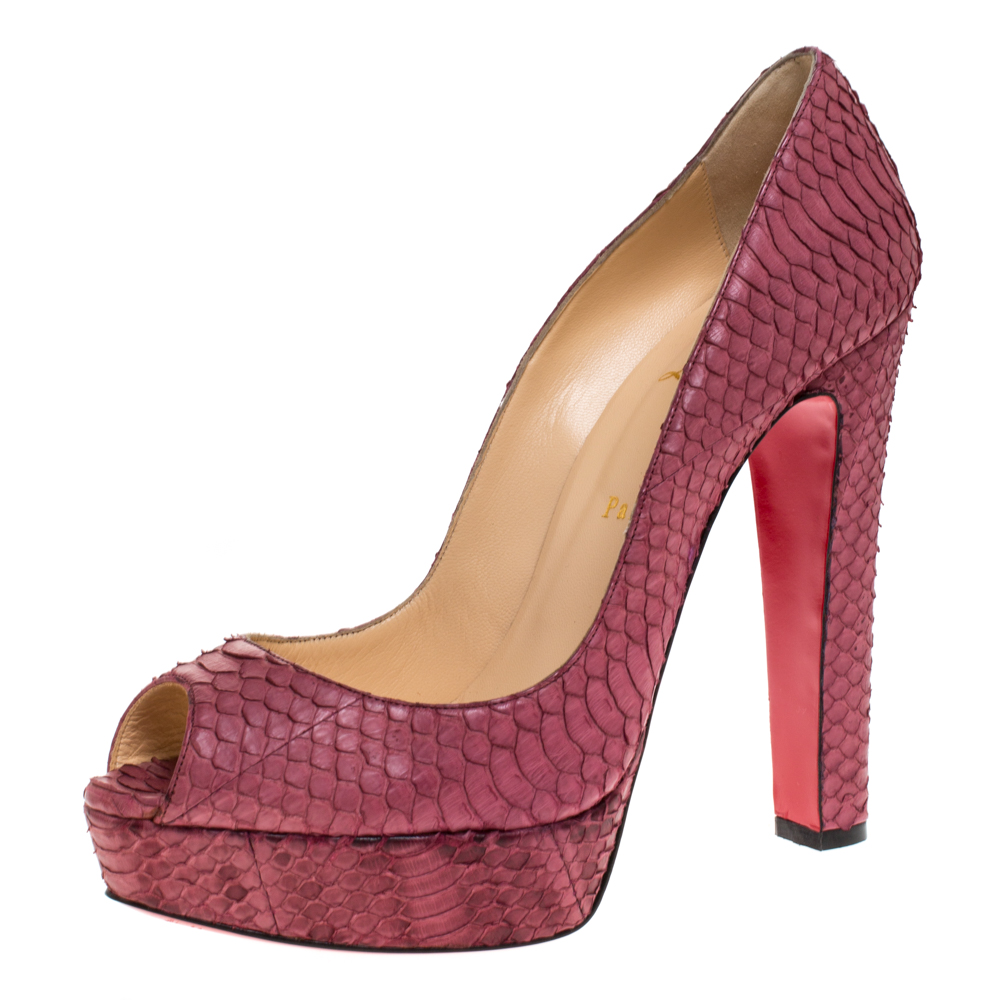 Stand out from a crowd with this gorgeous pair of Louboutins that exude high fashion with class Crafted from python leather this is a creation from their Lady Peep collection. They feature a pretty pink shade with peep toes and a textured exterior. Completed with leather insoles block heels and the signature red soles these pumps are a dream you can add to your collection NOTE: AVAILABLE FOR UAE CUSTOMERS ONLY