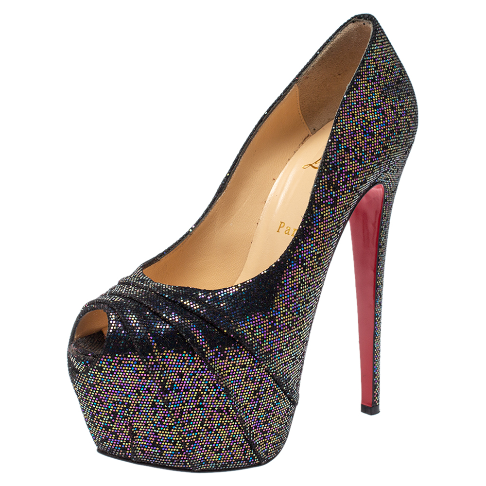 Stun the crowd when you wear these 160 Spotlight pumps by Christian Louboutin They are made from black hued glitter fabric and feature the signature red soles. These 16 cm high heeled platform pumps are leather lined with the brand logos.