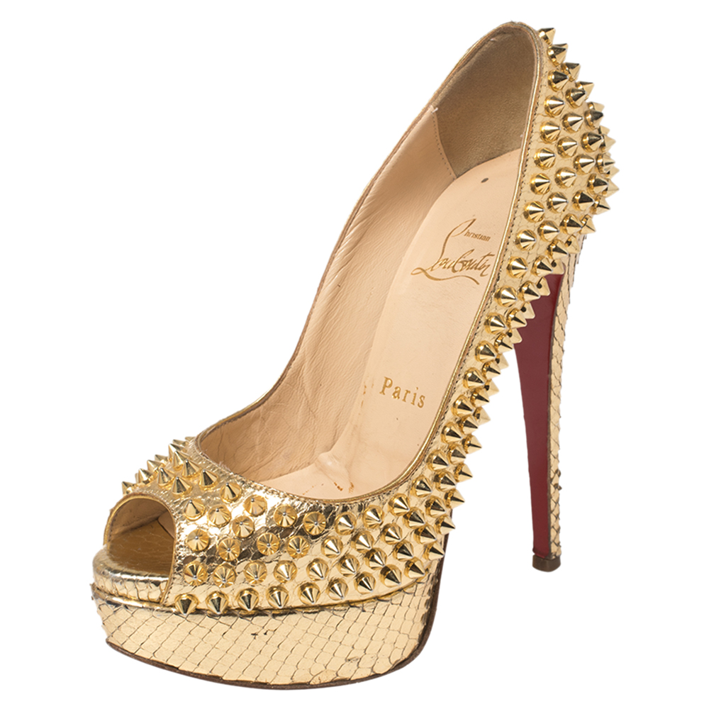 Bring home this meticulously designed pair of Christian Louboutin platform pumps to nail stunning looks at all times Crafted out of python leather this gold creation is from the Lady Peep collection. The CL peep toe pumps are elevated on platforms and stiletto heels. NOTE: AVAILABLE FOR UAE CUSTOMERS ONLY