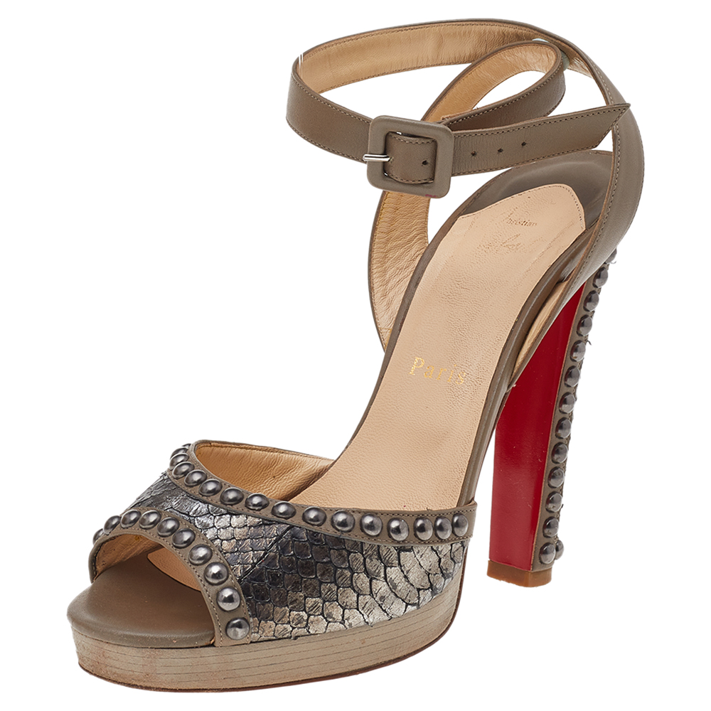 These sandals by Christian Louboutin have been crafted exquisitely. They are made from snakeskin and leather and come in a lovely shade of brown. They feature platforms buckled ankle straps high heels leather lined insoles and signature red soles. They will add an edge to your feet and elevate every outfit they are paired with.