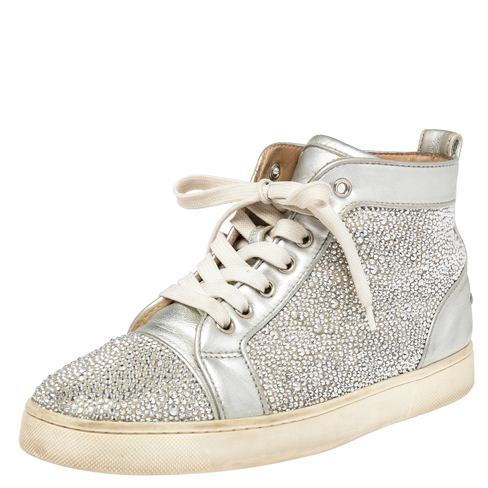 These Christian Louboutins Louis sneakers are designed in a silver leather body with crystal detail all over for a dazzling look. Set on a rubber sole this pair features lace ups and comfortable insoles making it easy to slip in and out. Wear with your weekend looks while out and about with friends.