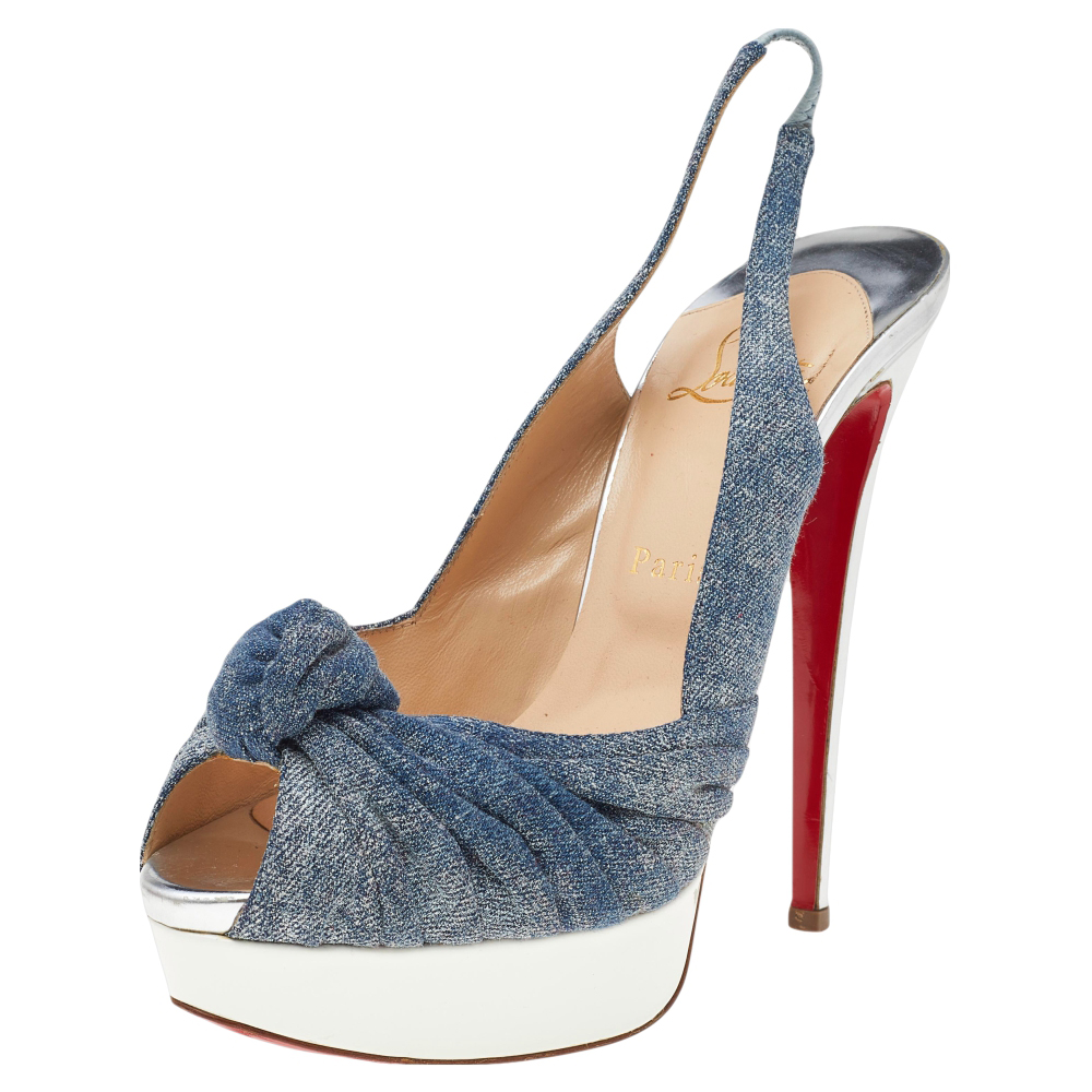 You wouldn't wish to miss this astounding pair of Jenny platform pumps from Christian Louboutin. Crafted in Italy they are made of blue denim and are styled with knotted vamps. This pair comes with slingback ankle straps platforms and 14.5 cm heels. They come with leather lined insoles lining and signature red soles.