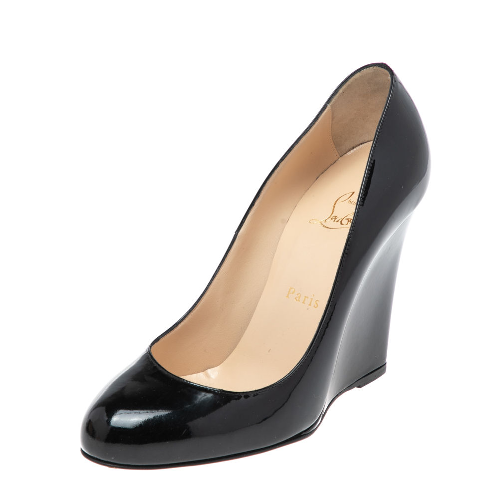 These black pumps from Christian Louboutin flaunt a classic design and are a must have for your closet Made luxuriously from patent leather they are finished with wedge heels leather lined insoles and rounded toes. A truly fabulous pair to go with any outfit