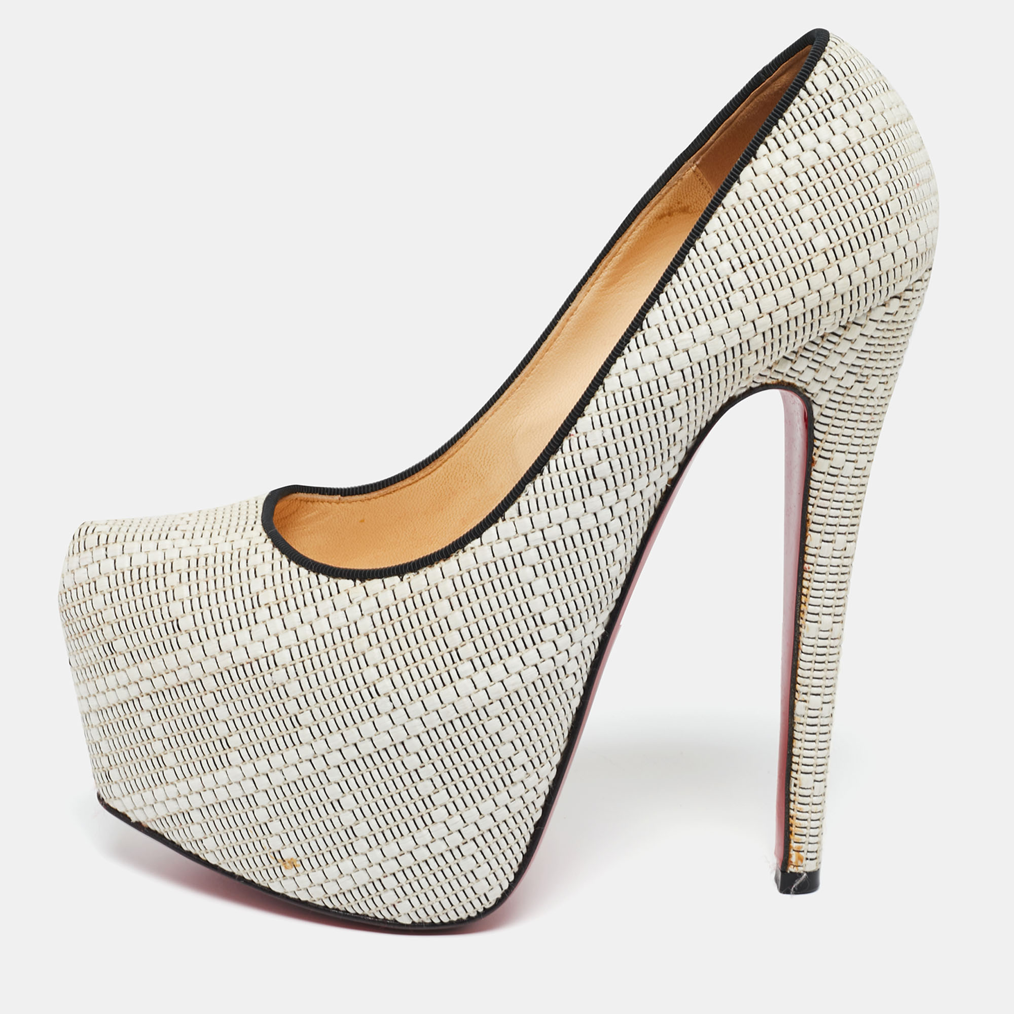 Take your love for Louboutins to new heights by adding this gorgeous pair to your collection. The stunning pumps are covered in raffia and elevated on platforms and 15 cm heels. The red soles add the signature finish that CL is loved for