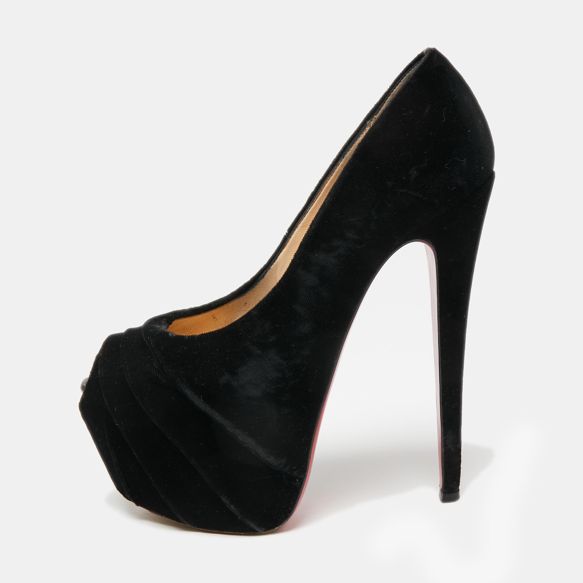 Made distinctive by the draped detailing on the vamps these Christian Louboutins have been crafted from soft velvet. In addition to ultra high heels they have concealed platforms for extra support. The black pumps also feature peep toes and are finished with the signature red soles.