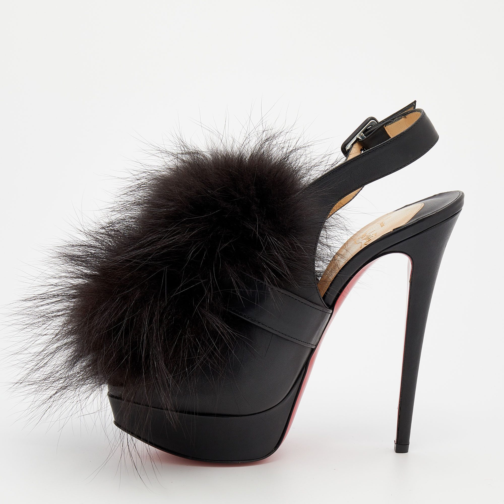These splendid sandals from Christian Louboutin have an ultra modern feel with an artistic edge. The leather exterior adorned with extravagant fur trims on the front is visually appealing and the towering 15 cm heels offer loads of glamour. Buckles secure these black shoes safely. Bold and feminine they will be incredible with skinny pants or short dresses.
