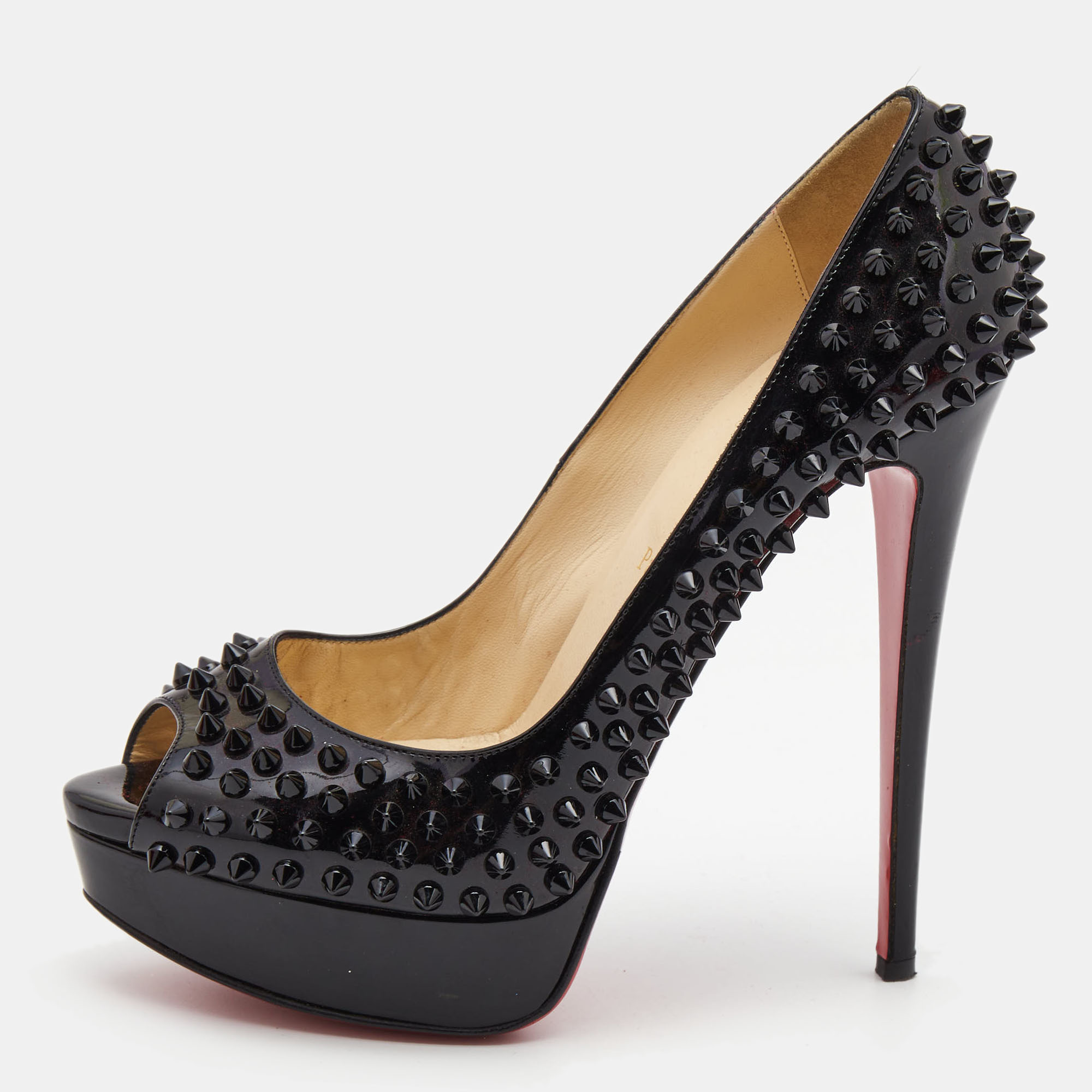 Stand out from the crowd with this pair of Christian Louboutin pumps that exude high fashion with class. Crafted from patent leather this is a creation from their Lady Peep collection. It features a classy black shade with peep toe silhouette and chic spike detailing. Completed with leather insoles stiletto heels and signature red lacquered soles these shoes are a must have.