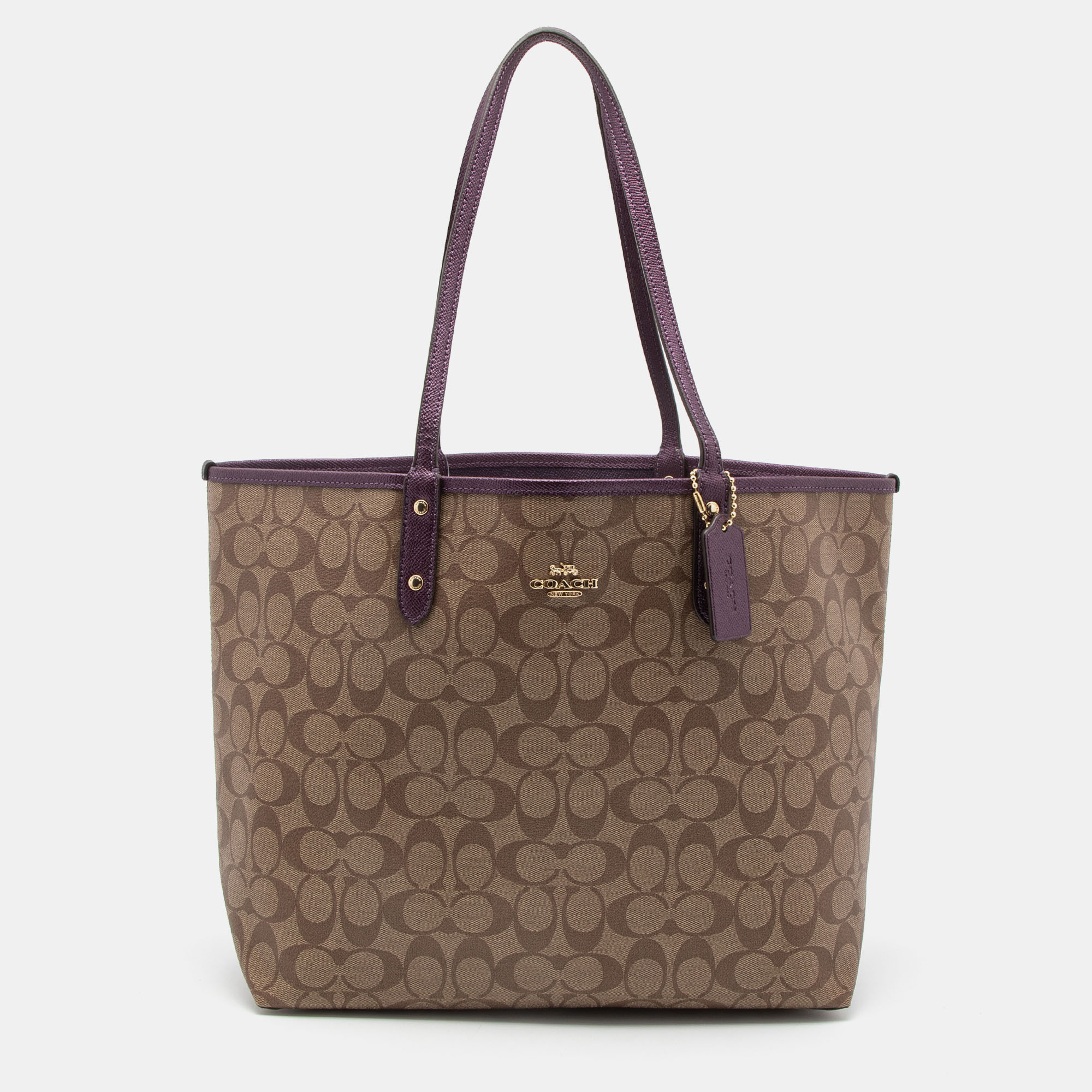 Pre Owned Coach Beige/Purple Signature Coated Canvas and Leather Reversible City Tote