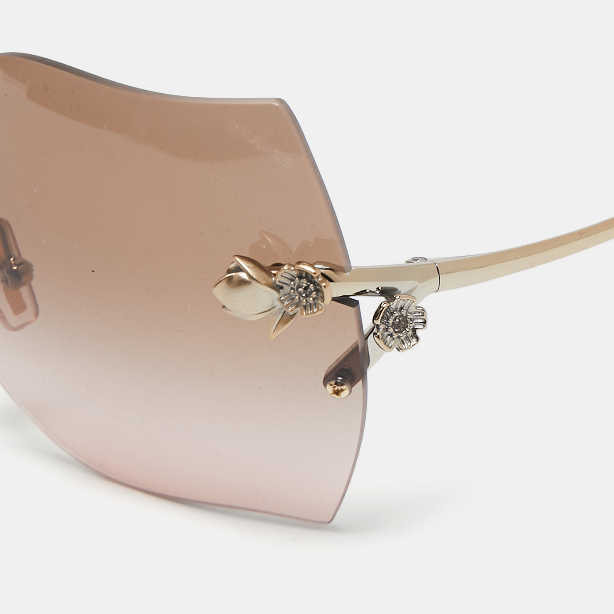 

Coach Pale Gold Tone/Brown HC7082B Rimless Butterfly Sunglasses