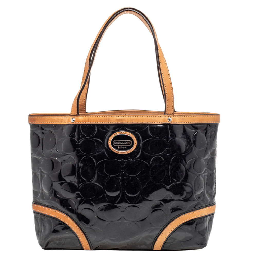 Every modern day wardrobe needs a Coach handbag like this. Designed to perfection and crafted from the brands signature embossed patent leather it comes in lovely shades of black with beige leather trims. It is equipped with dual handles a satin lined interior and silver tone hardware. Grab this functional beauty now