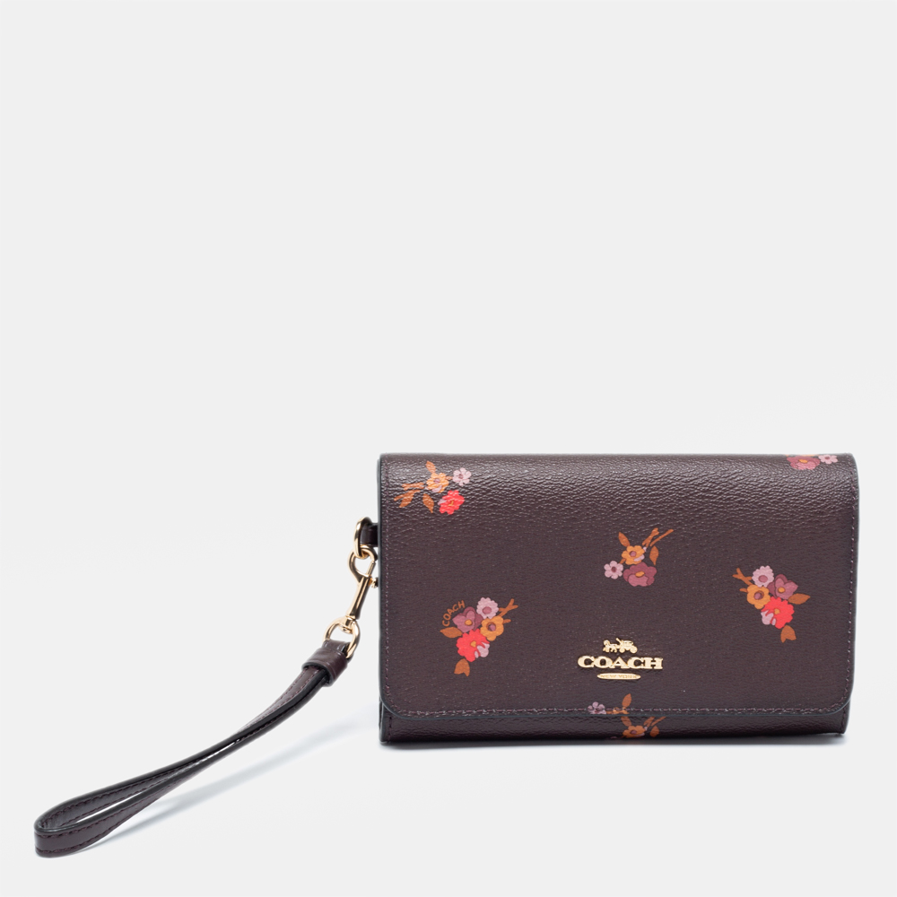 Click to view more detailed imagery on our partner's website Pre-owned Coach Oxblood Red Baby Bouquet Print Leather Flap Phone Wristlet Wallet