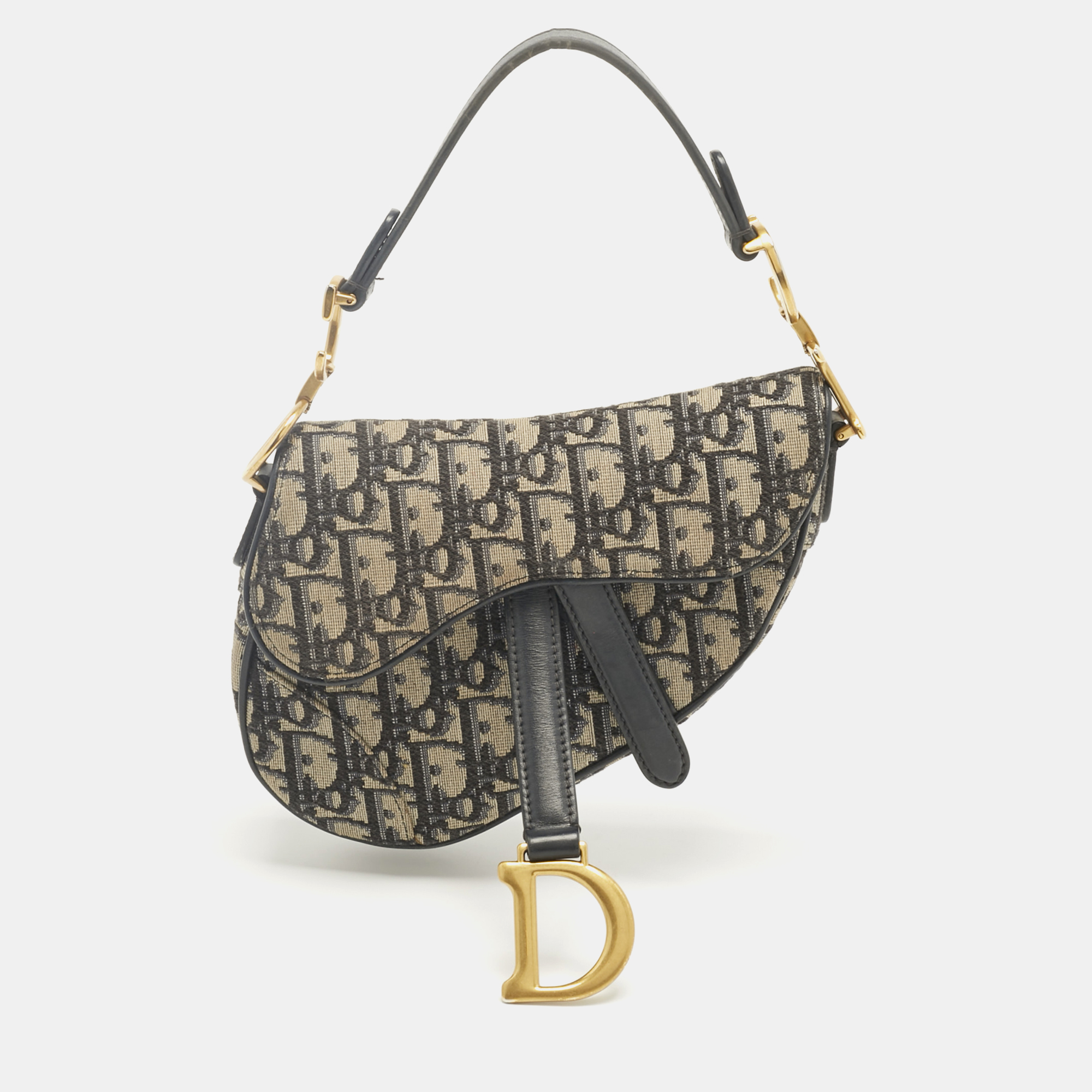 Click to view more detailed imagery on our partner's website Pre-owned Dior Navy Blue Oblique Canvas And Leather Mini Saddle Bag