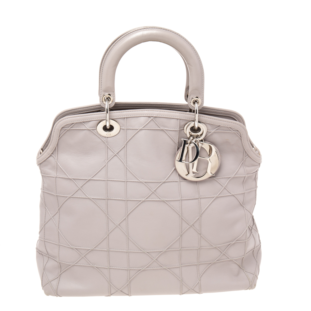 Presented by the House of Dior this stunning Granville tote is a true statement accessory. It is crafted using pale lilac Cannage leather with signature D. i. o. r. charms perched on the front. This tote provides two handles silver tone hardware and a spacious nylon leather interior. This Dior tote is worth owning
