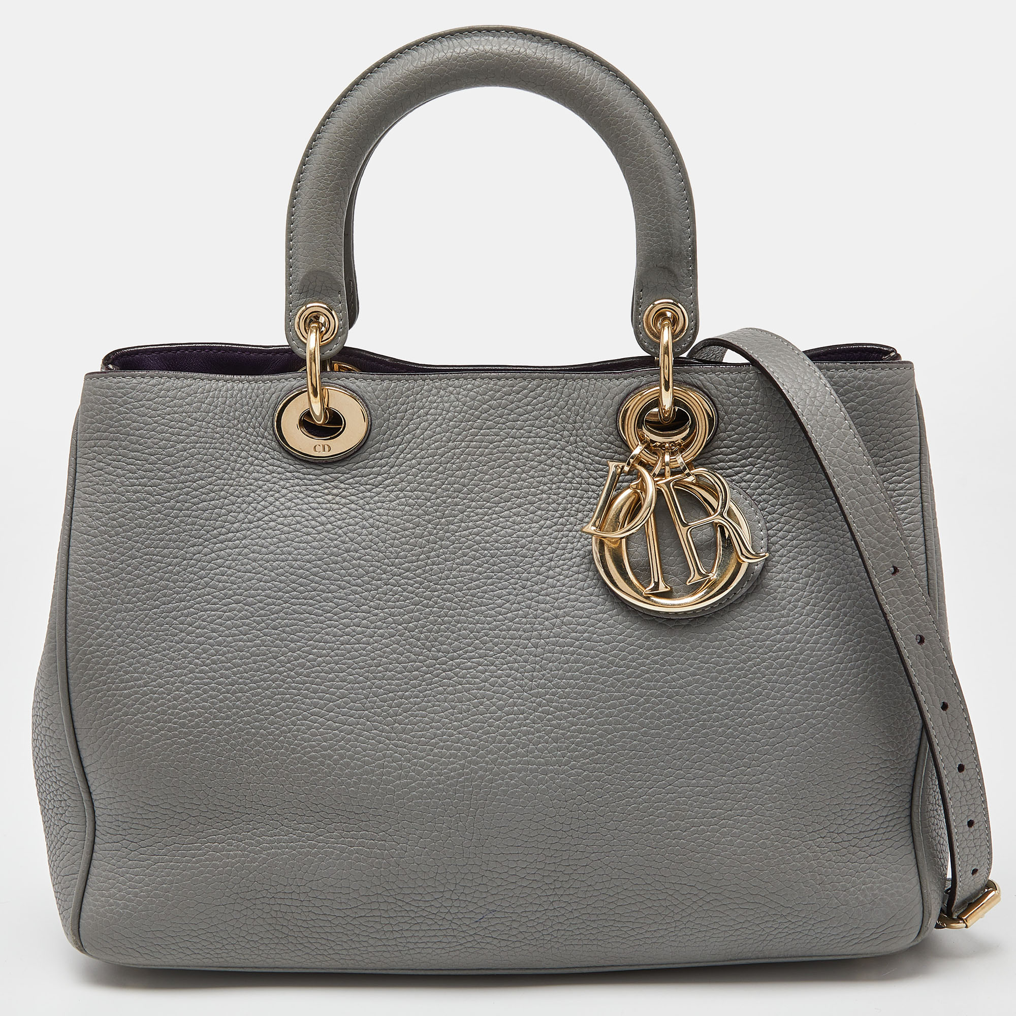 The Diorissimo perfectly captures the refined craftsmanship and the brands vision of timeless elegance. The spacious interior makes this Dior tote a highly functional accessory. Created from leather it is complemented with top dual handles a shoulder strap and gold tone hardware. The DIOR letter charms on the front lend it a luxe finish.