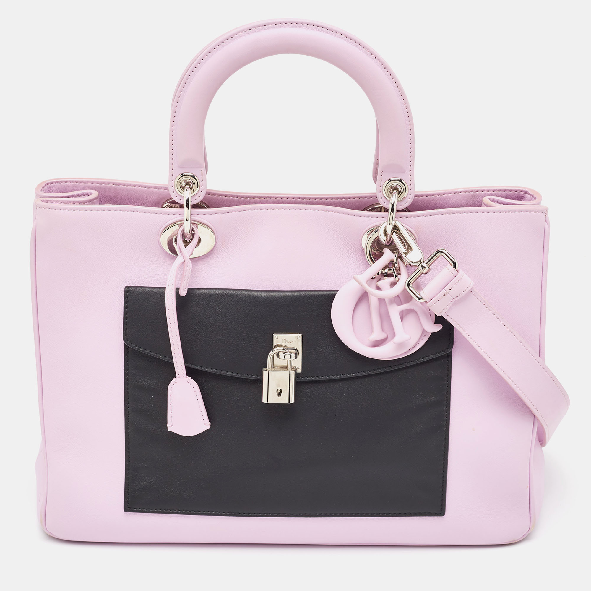 The Lady Dior tote is a Dior creation that has gained recognition worldwide and is today a coveted bag that every fashionista craves to possess. This lilac and black tote has been crafted from leather and it carries flap pockets both on the front and back. It is equipped with a leather interior and two top handles. The gorgeous piece is complete with the classic Dior letter charms.