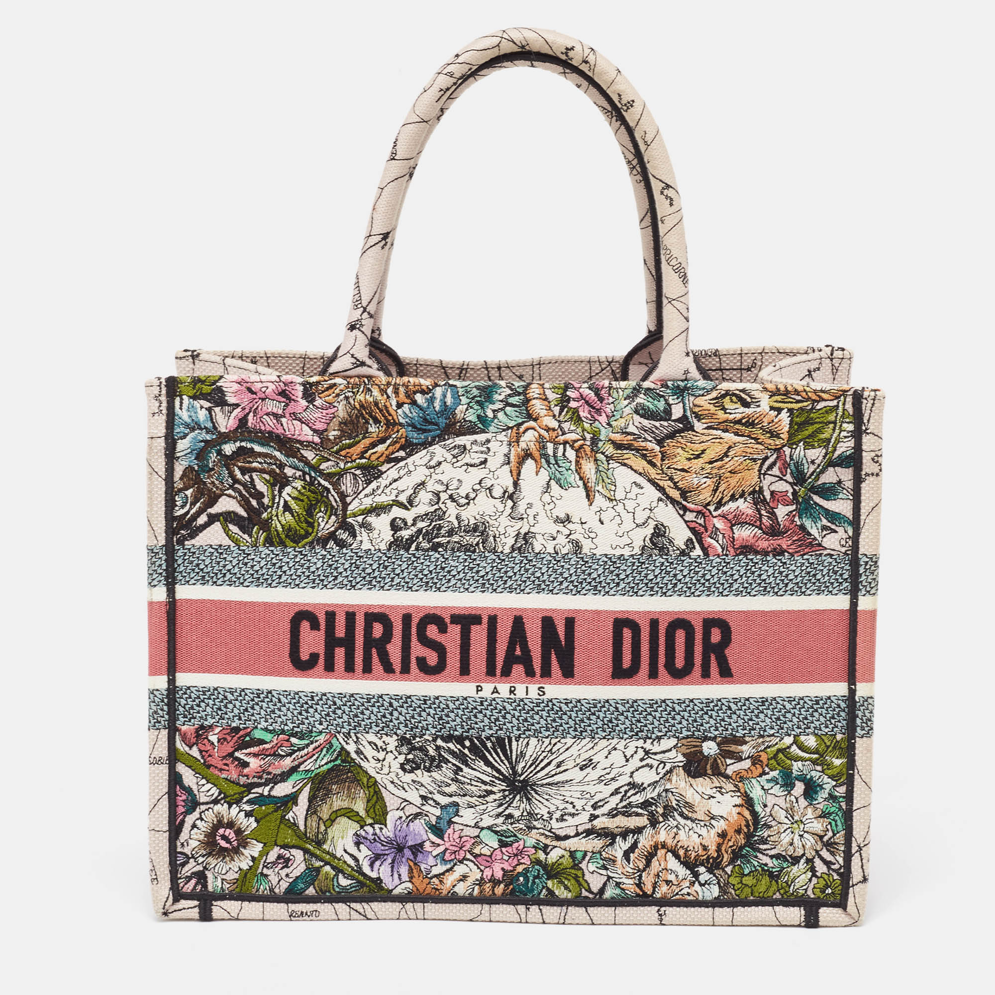 The Book Tote features a canvas body rolled handles and a lined interior. Elevate your every day with this Dior tote. Meticulously designed it seamlessly blends functionality with luxury offering the perfect accessory to showcase your discerning style while effortlessly carrying your essentials.