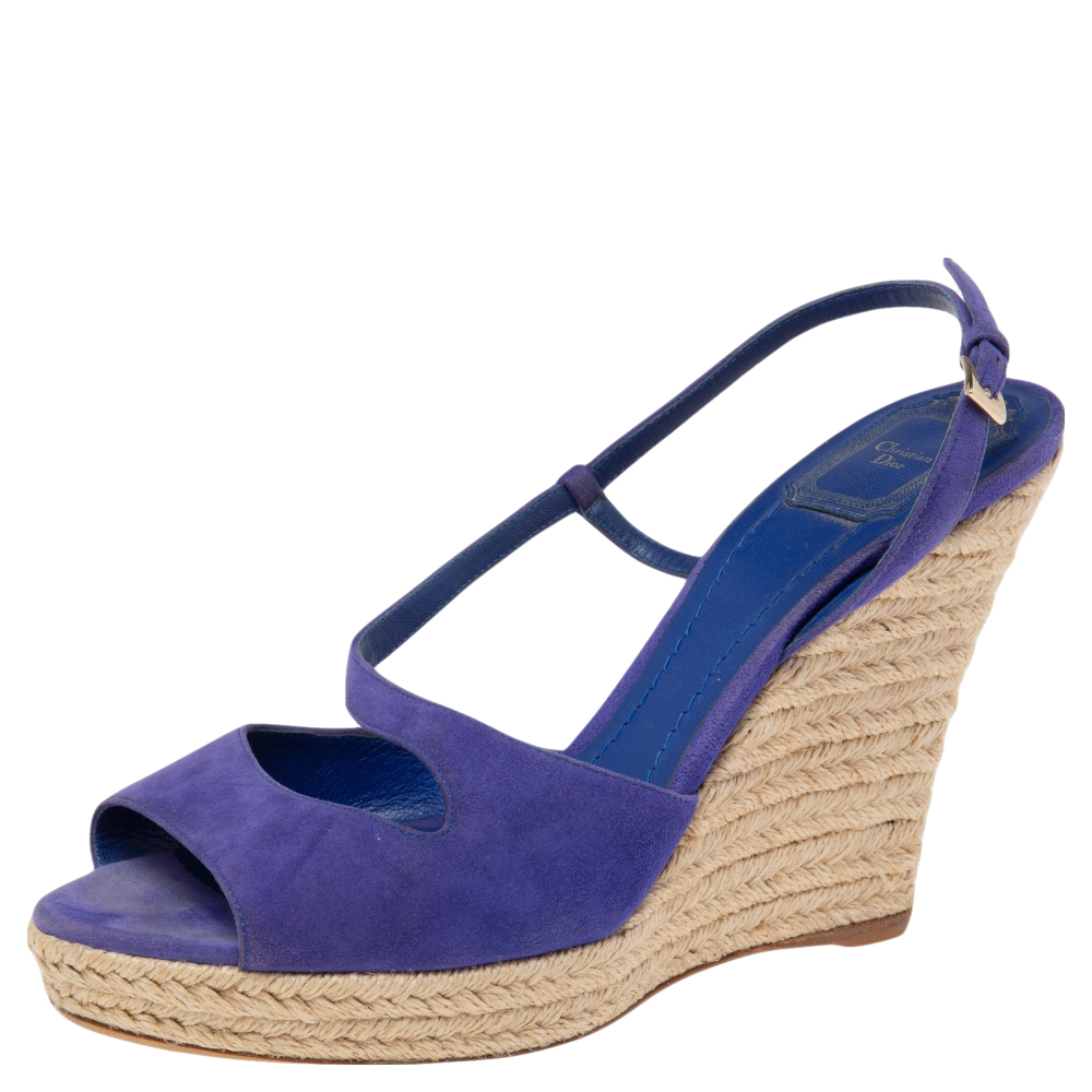 Gleaming with beauty this pair of wedge sandals by Dior has only the finest details. Theyve been wonderfully styled with blue hued suede straps and elevated on espadrille wedges. Complete with buckle straps and leather insoles this pair is a must have.