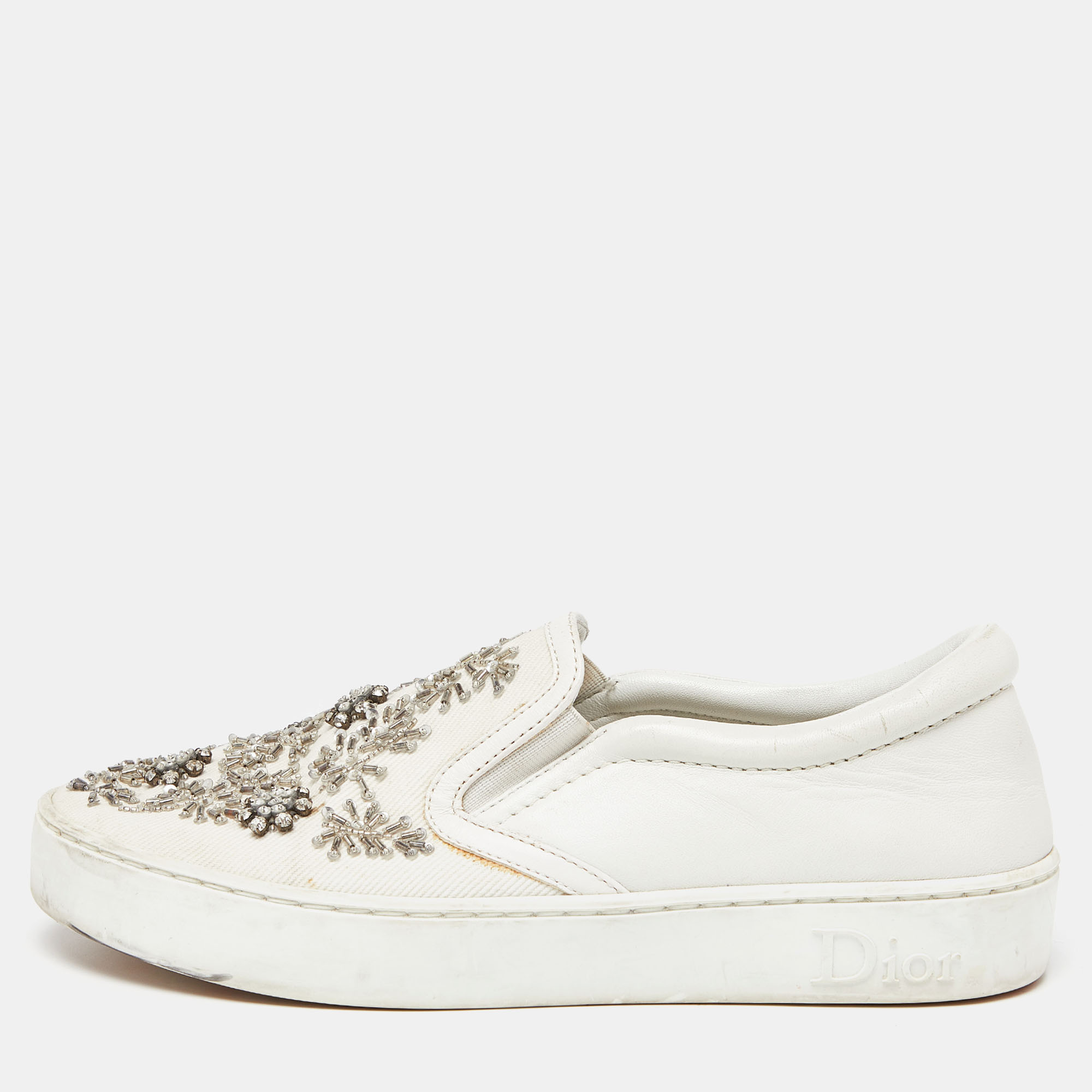 Easy to slip into these chic sneakers from Dior will be your new favorite They have been crafted from white leather and are complete with embellished uppers.