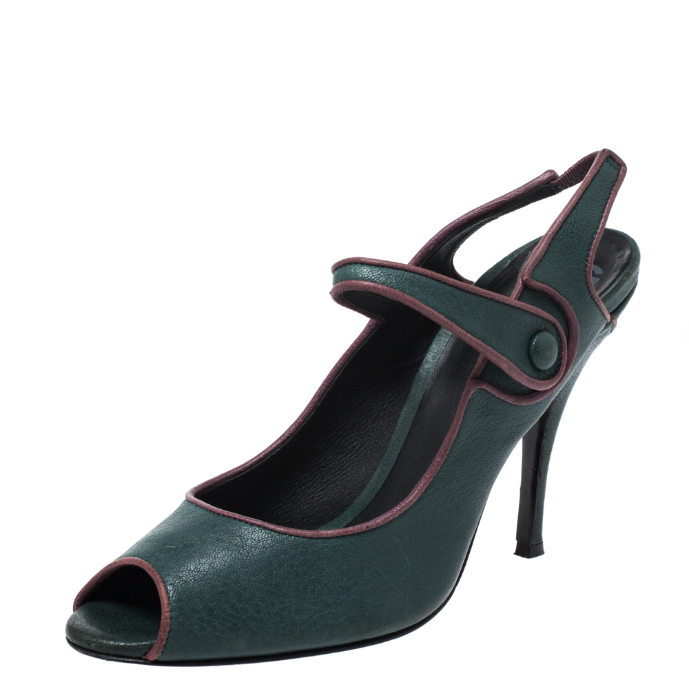 Take a walk on the wild side with these Mary Jane pumps by Dolce and Gabbana. The exterior is made from green leather. These shoes come with 11.5 cm high heels and peep toes. The insoles are leather lined and have brand logos.