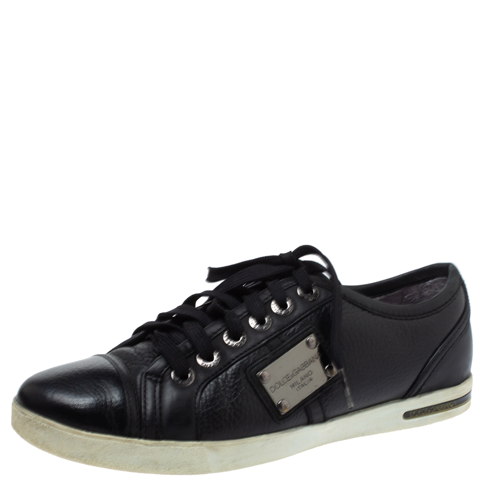 Sturdy and stylish these low top sneakers by Dolce and Gabbana are perfect with casuals. They have been crafted from quality leather in a classic shade of black. They are styled with lace ups logo detailing on the sides and rubber soles.
