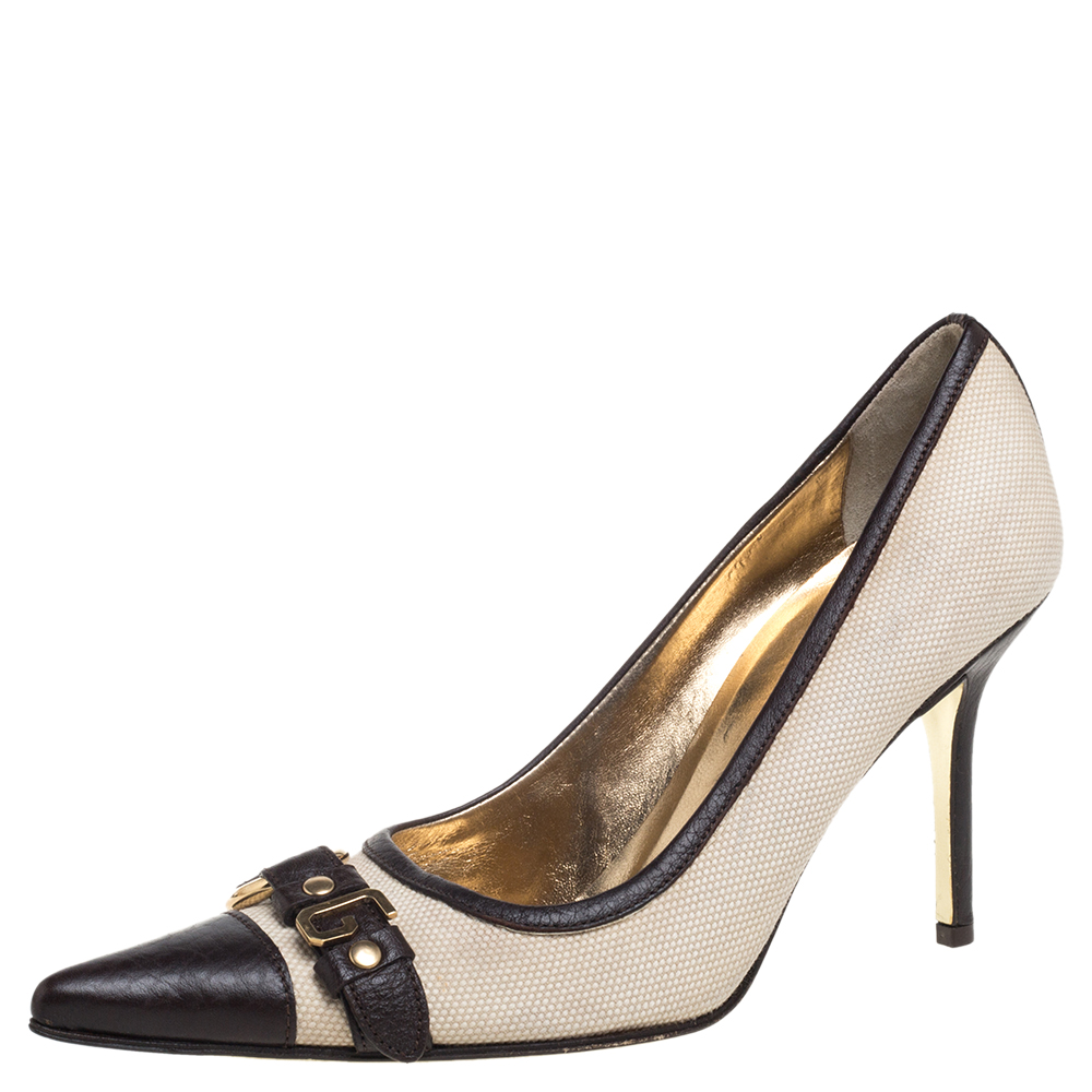 Pick this pair of Dolce and Gabbana pumps to flaunt a simple yet stylish look. Lend an uber chic look to your ensemble in this pair of pointed toe pumps crafted from canvas and leather. Let your shoes talk for your sense of style when you don this pair of beige pumps on a day out.