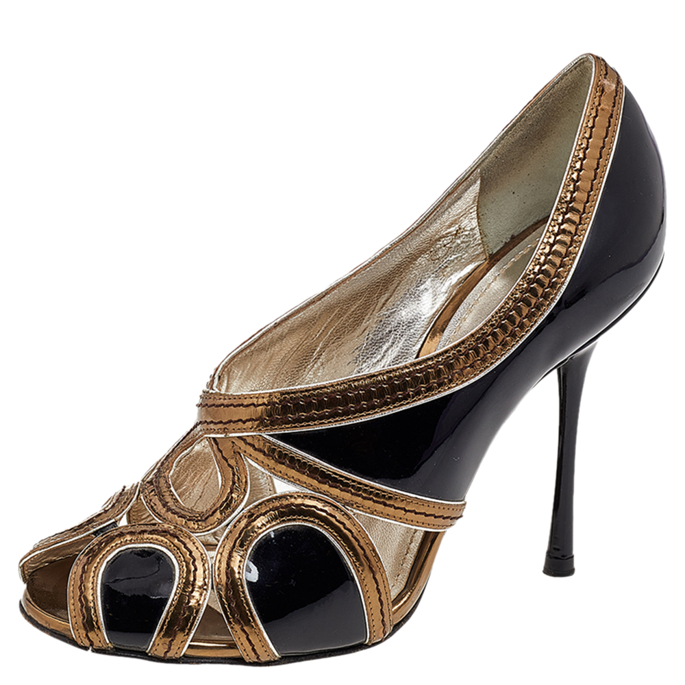 Bring elegance and class to your outfit with these pumps from the House of Dolce and Gabbana. They are made from black gold patent leather and leather and feature peep toes a cut out upper and slim heels. Add these pumps to your collection and amp up your trend factor