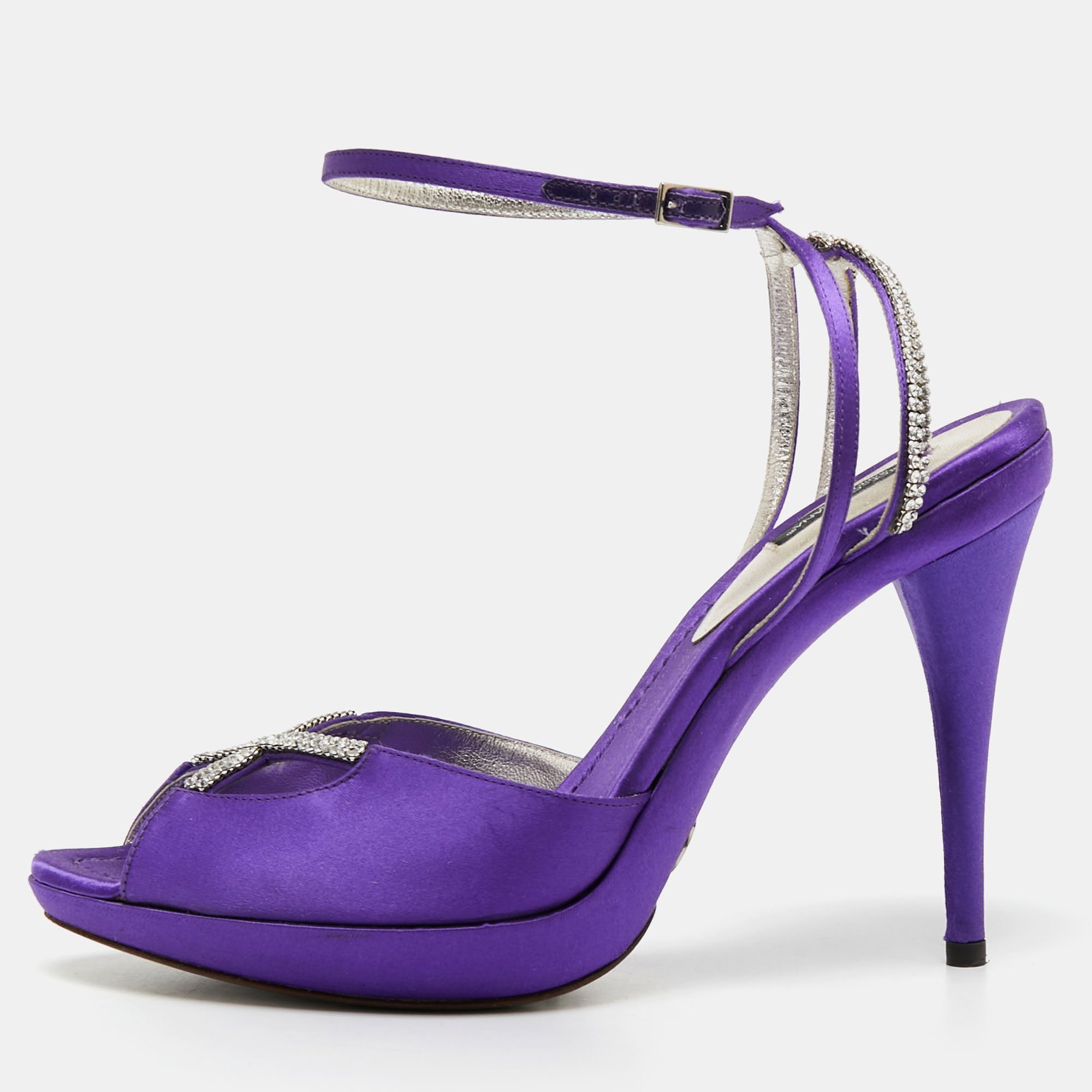 These sandals from the House of Dolce and Gabbana will add a chic touch to your outfit. They are created using purple satin which is elevated with crystal embellishments. They flaunt open toes an ankle strap and slim heels. Stay stylish all day with these gorgeous sandals.
