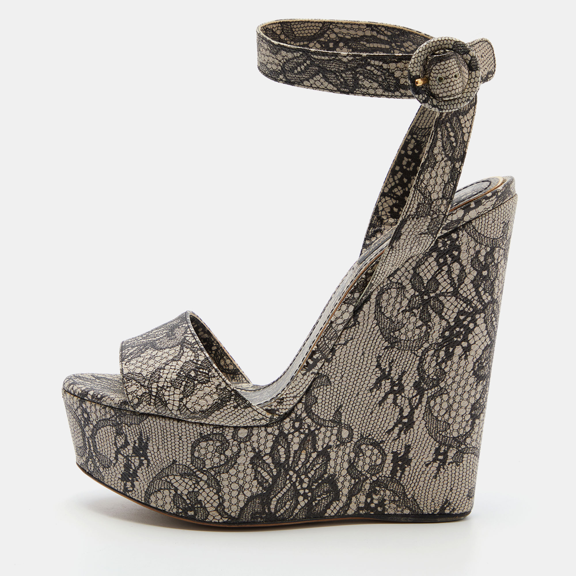 These Dolce and Gabbana sandals with their contemporary shape perfectly capture the elegance of a woman. Beautifully crafted from lace they are made striking with striking print and are secured with an ankle buckle closure. The wedge heels and platforms of this pair will reflect luxury and grace in every step.