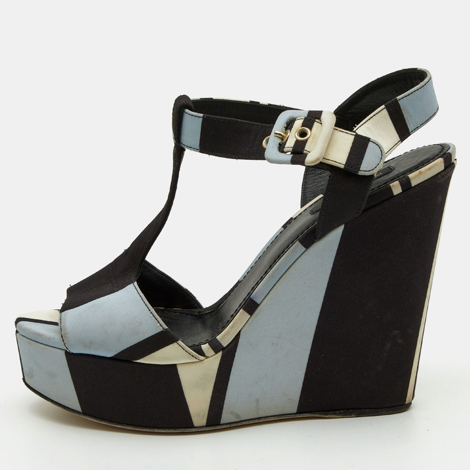 Dolce and Gabbanas Tri Color Printed Fabric T Strap Wedge Sandals feature a vibrant unique print T strap design and comfortable wedge heel offering a blend of elegance and statement making style.