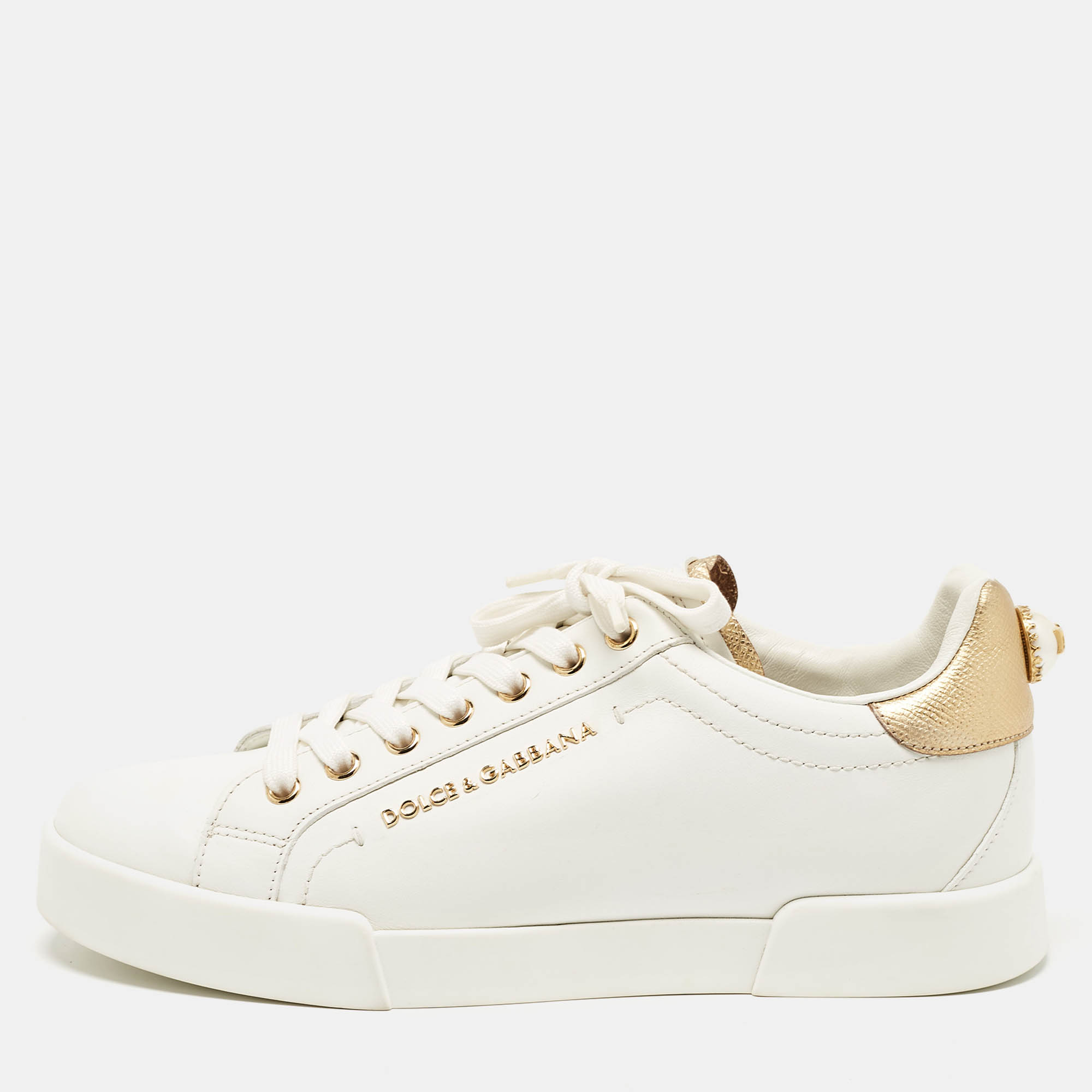 These Dolce and Gabbana sneakers are luxurious. They are crafted from white leather styled with lace ups and decorated with faux pearls on the counters. The sneakers are high in both appeal and comfort.